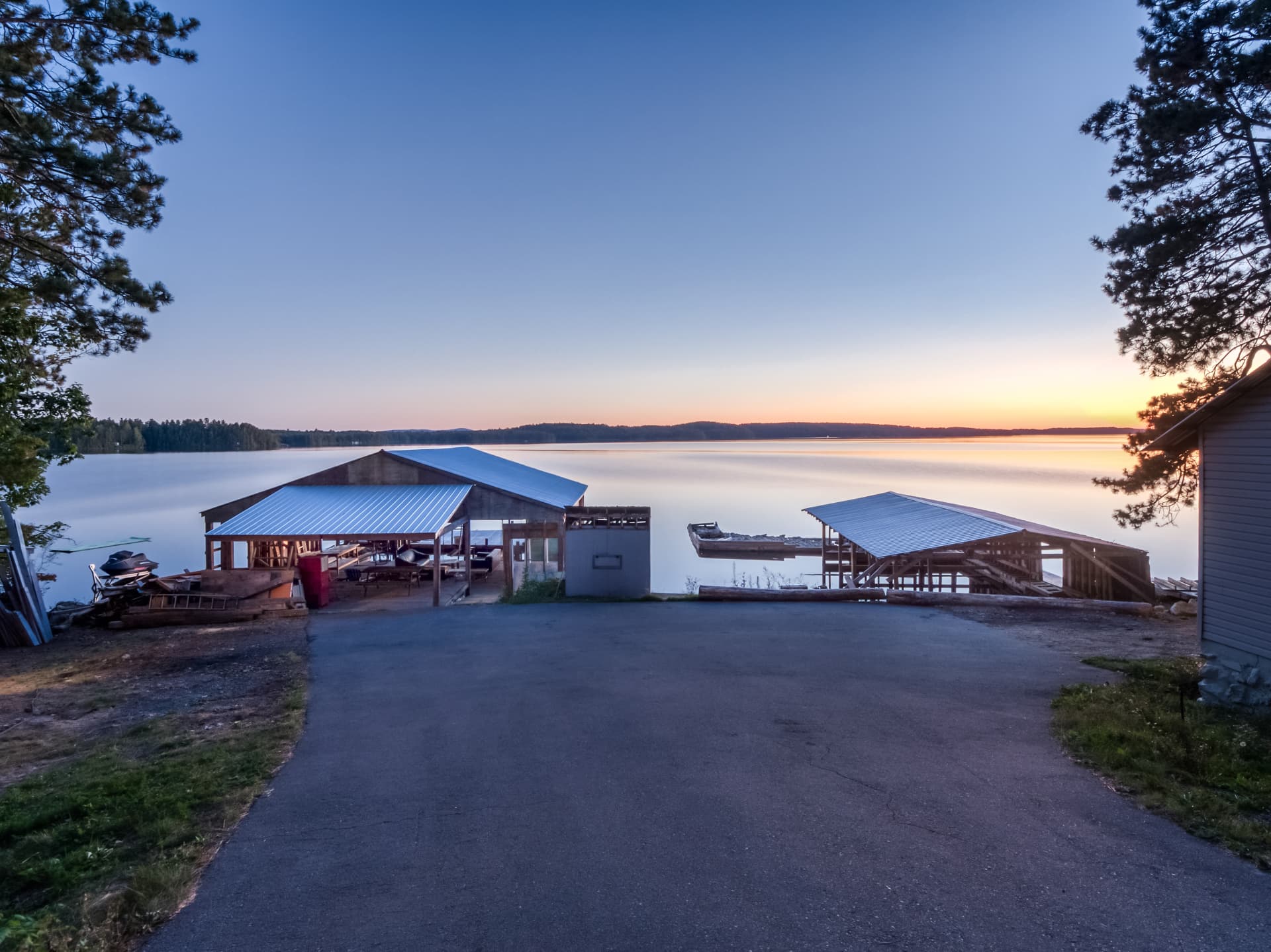 Lake Panache at sunset with the shoreline and the boathouse structures at 103A North Shore Road