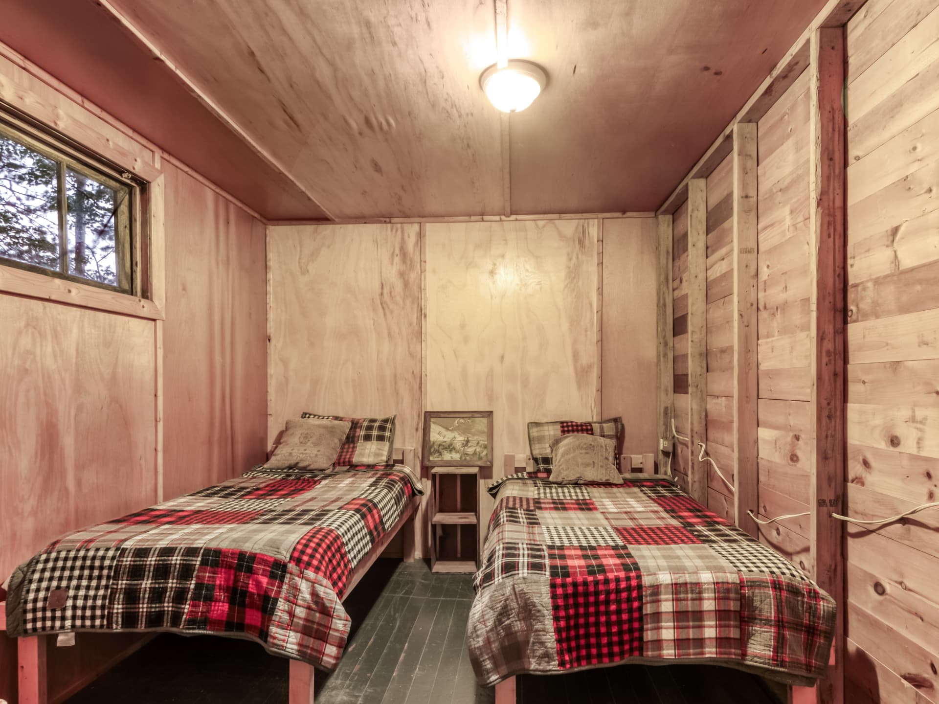 Wood-panelled cabin bedroom with twin beds