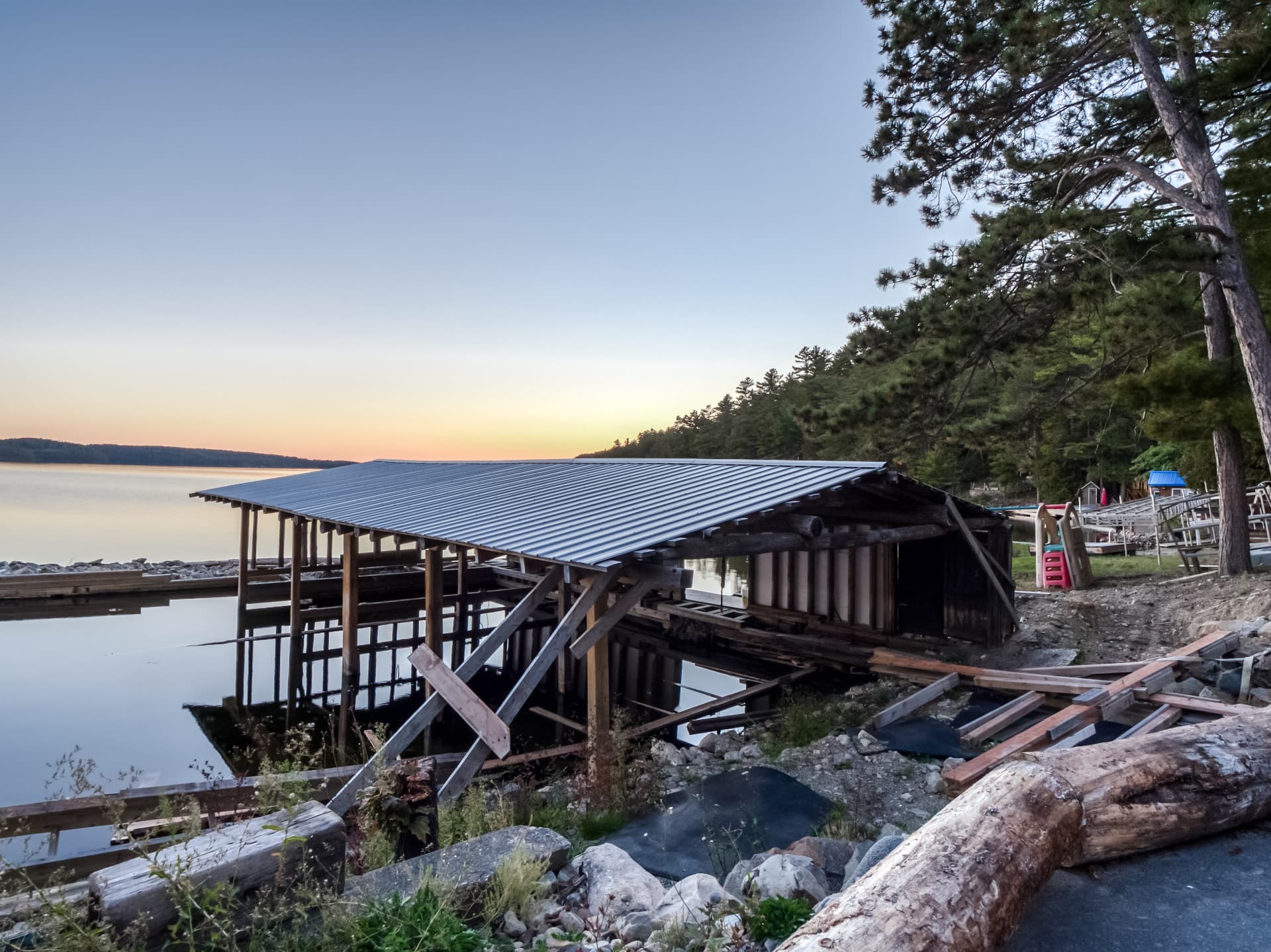 Boathouse structure on Lake Panache at dusk, sold in as-is condition