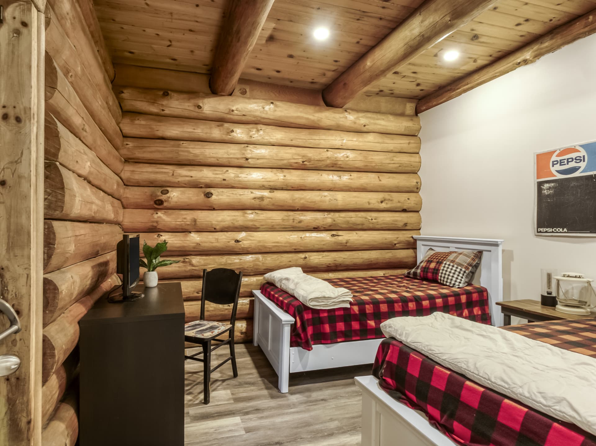 Bedroom in the log home with log walls and two beds