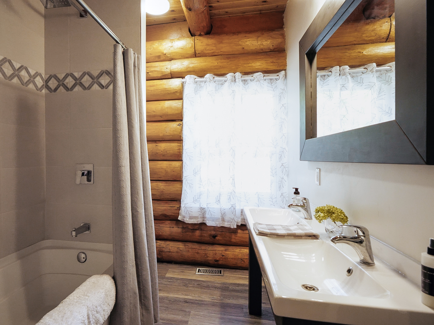 Main bathroom with a tub, shower, and double vanity