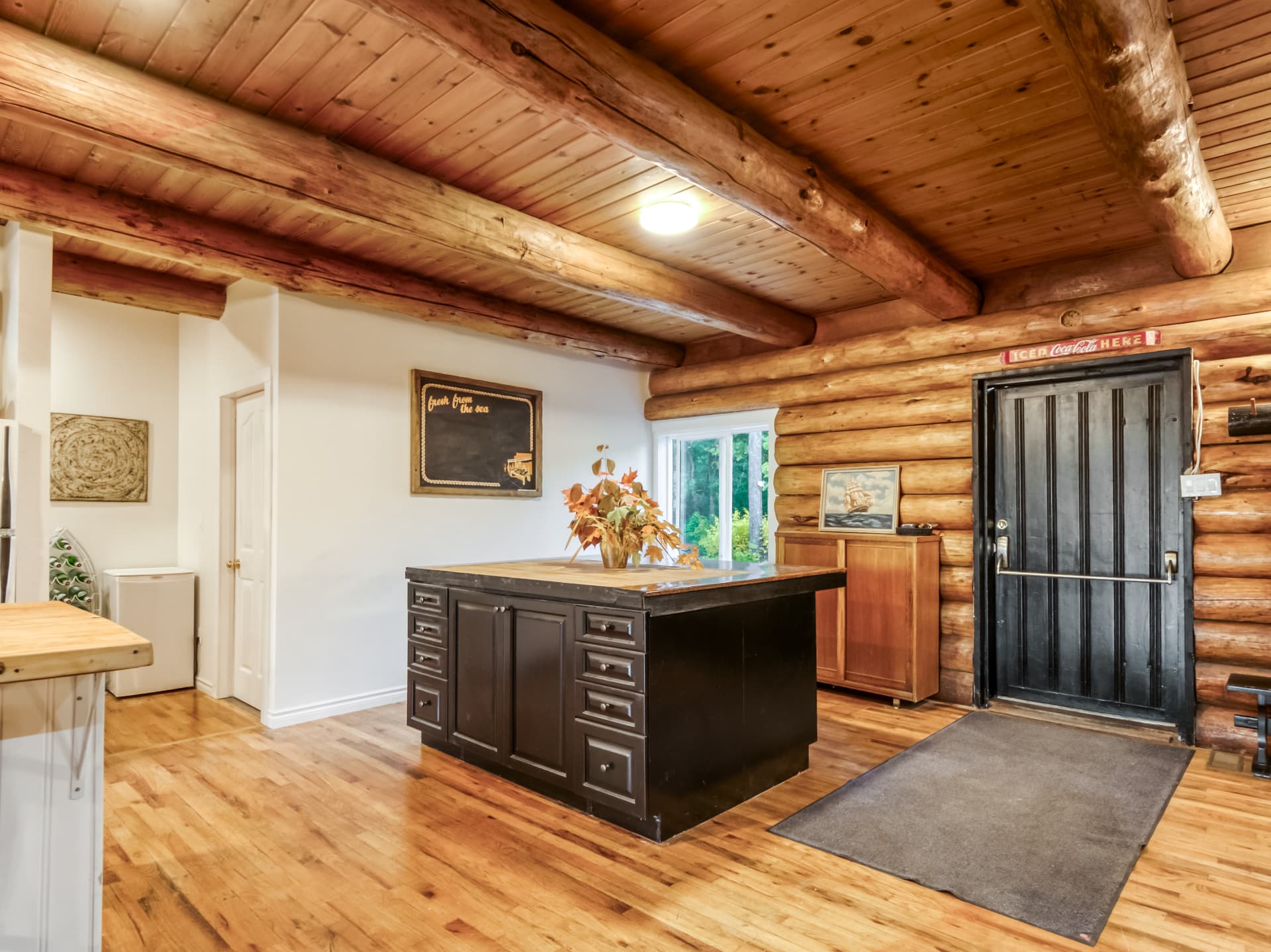 Kitchen island near the entry door of the log home