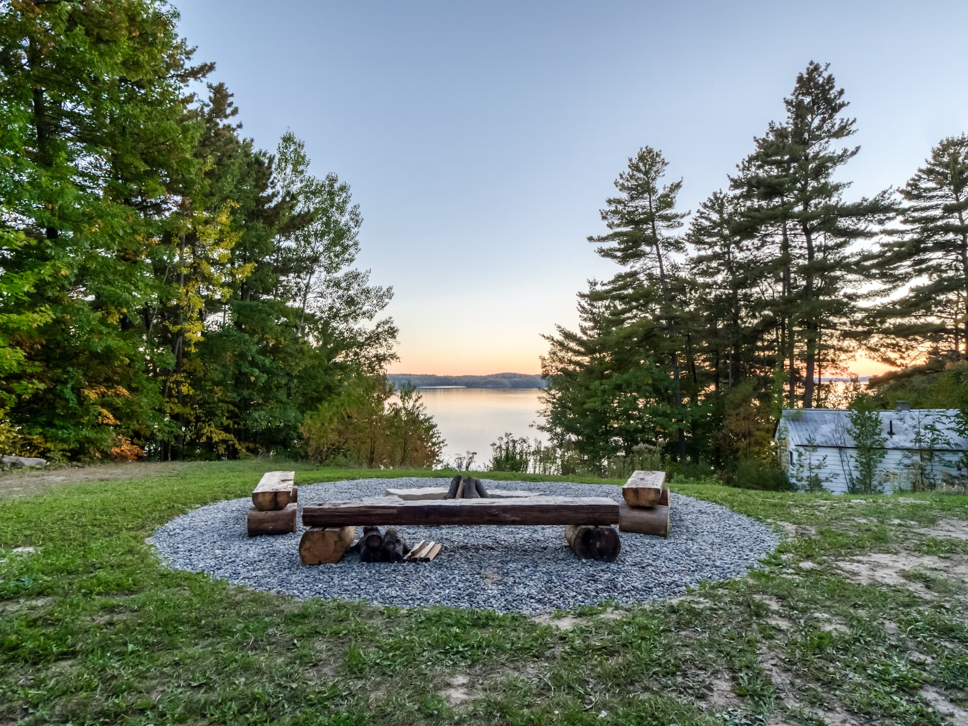 Firepit area with bench seating overlooking Lake Panache