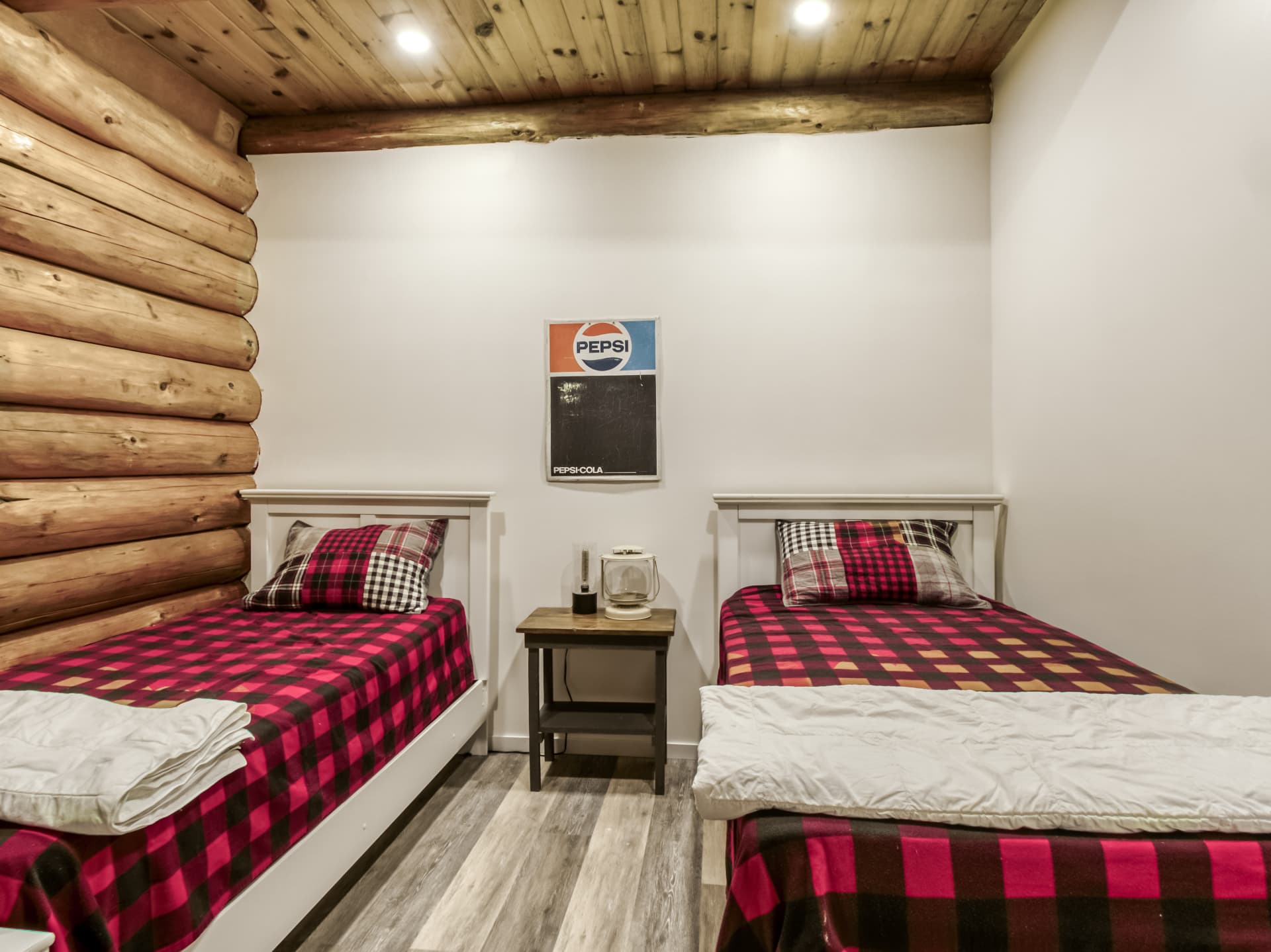 Room in the log home with log walls and two single beds